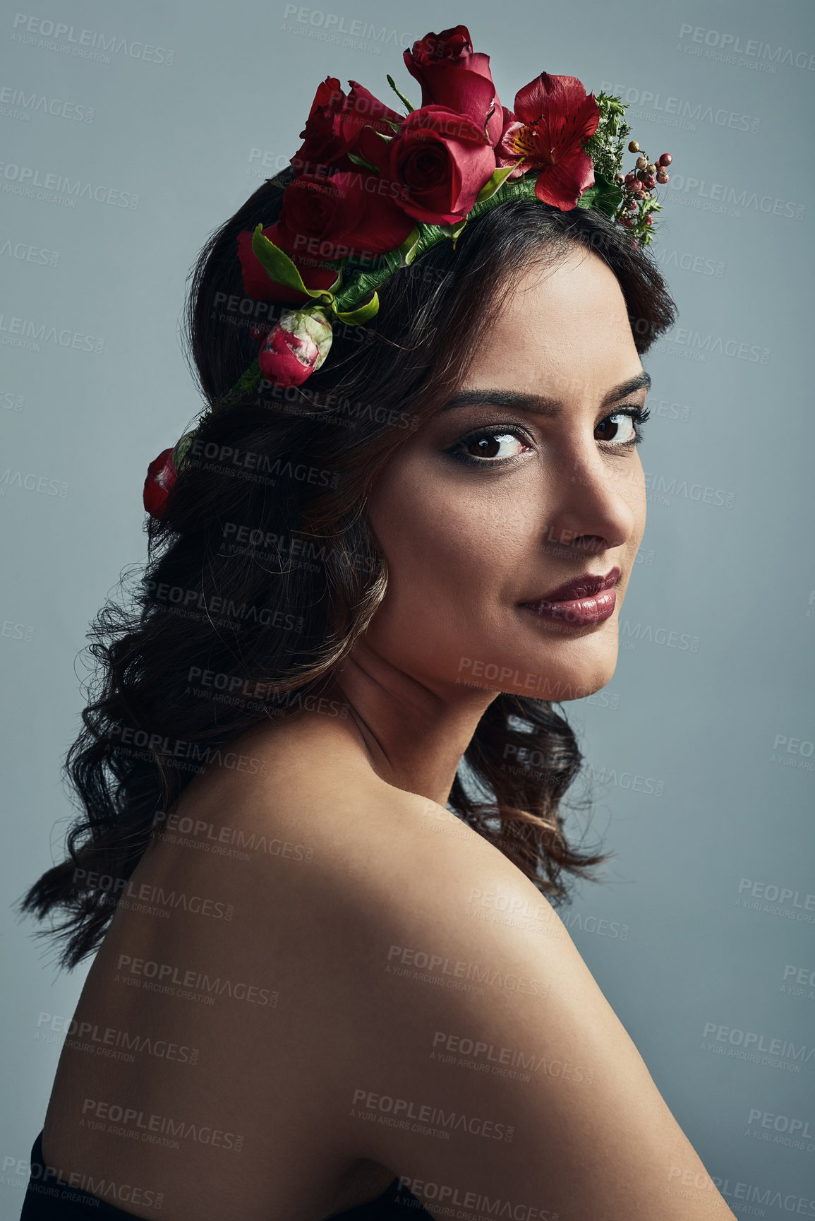 Buy stock photo Studio shot of a beautiful young woman wearing a floral head wreath against a grey background