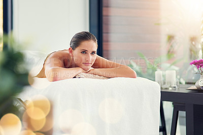 Buy stock photo Shot of a beautiful young woman lying on a massage table at the day spa