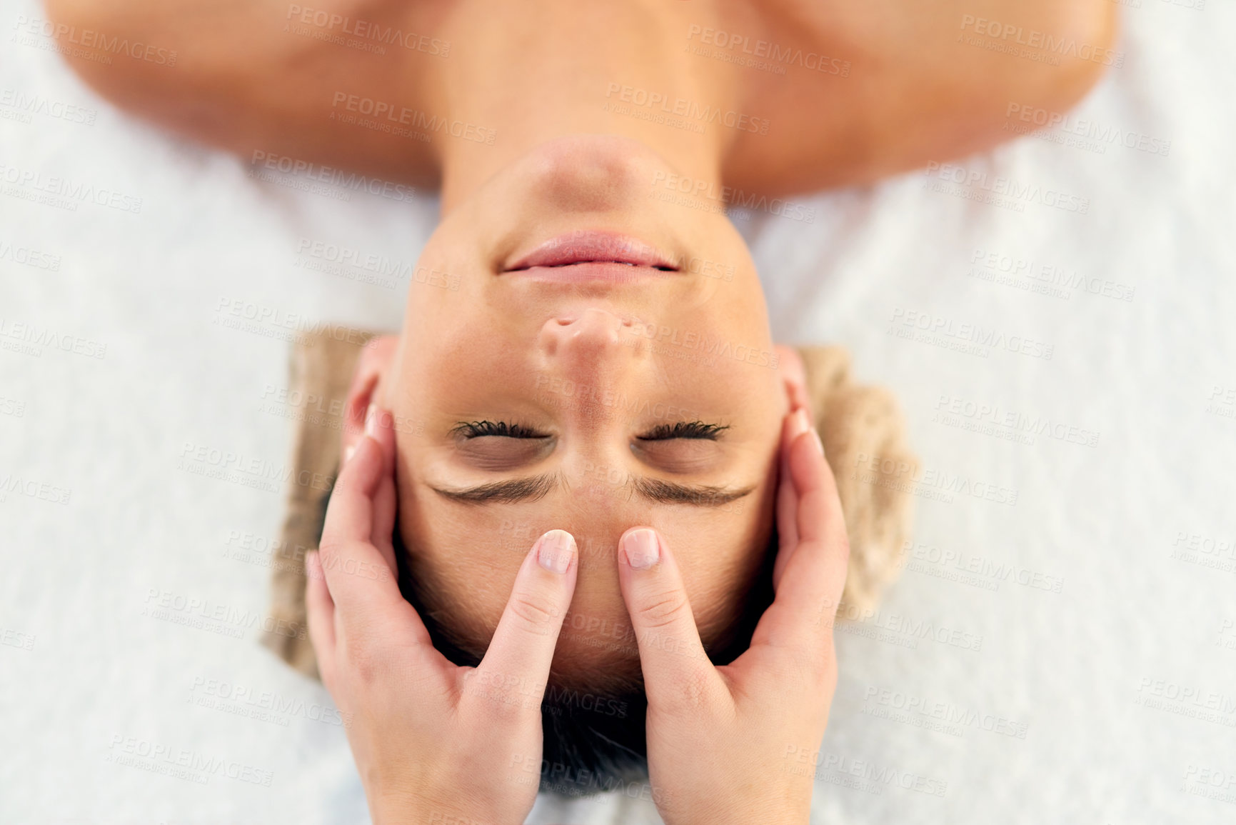 Buy stock photo Shot of a beautiful young woman lying on a massage table at the day spa