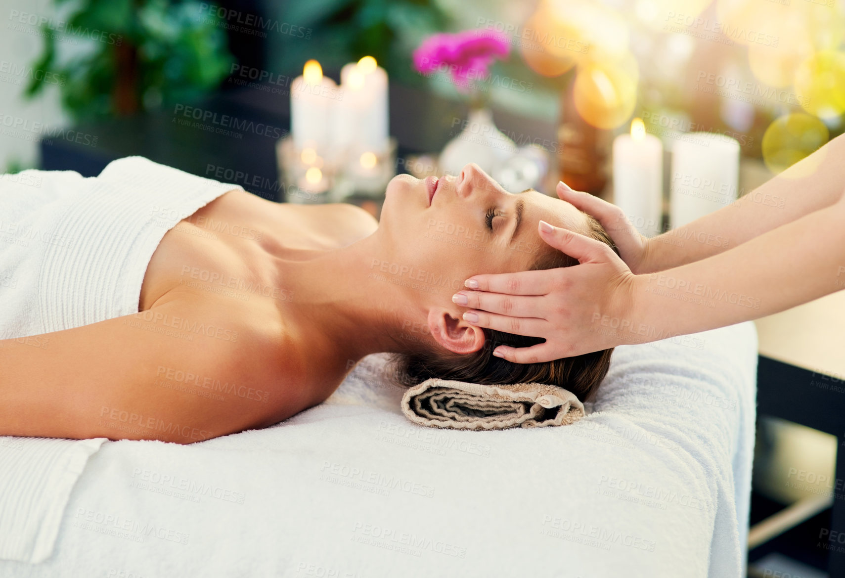 Buy stock photo Shot of a beautiful young woman lying on a massage table at the day spa