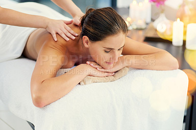Buy stock photo Shot of a beautiful young woman lying on a massage table at the day spa