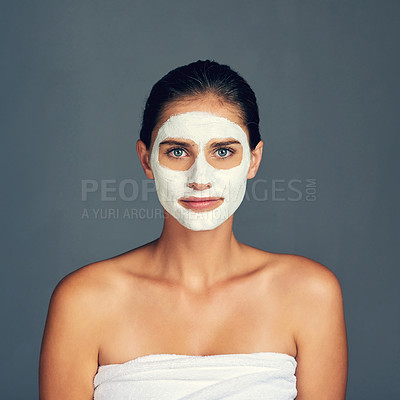 Buy stock photo Studio shot of a young woman wearing a face mask against a grey background