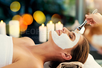 Buy stock photo Shot of a beautiful young woman lying on a massage table at the day spa