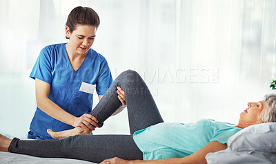 Buy stock photo Cropped shot of a young female carer assisting her senior patient in the hospital