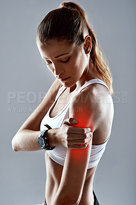 Buy stock photo Fitness injury, woman and hand on arm with red glow for sports, workout and gym in studio. Shoulder tear, pain and athlete with muscle for training, exercise and motivation on gray background