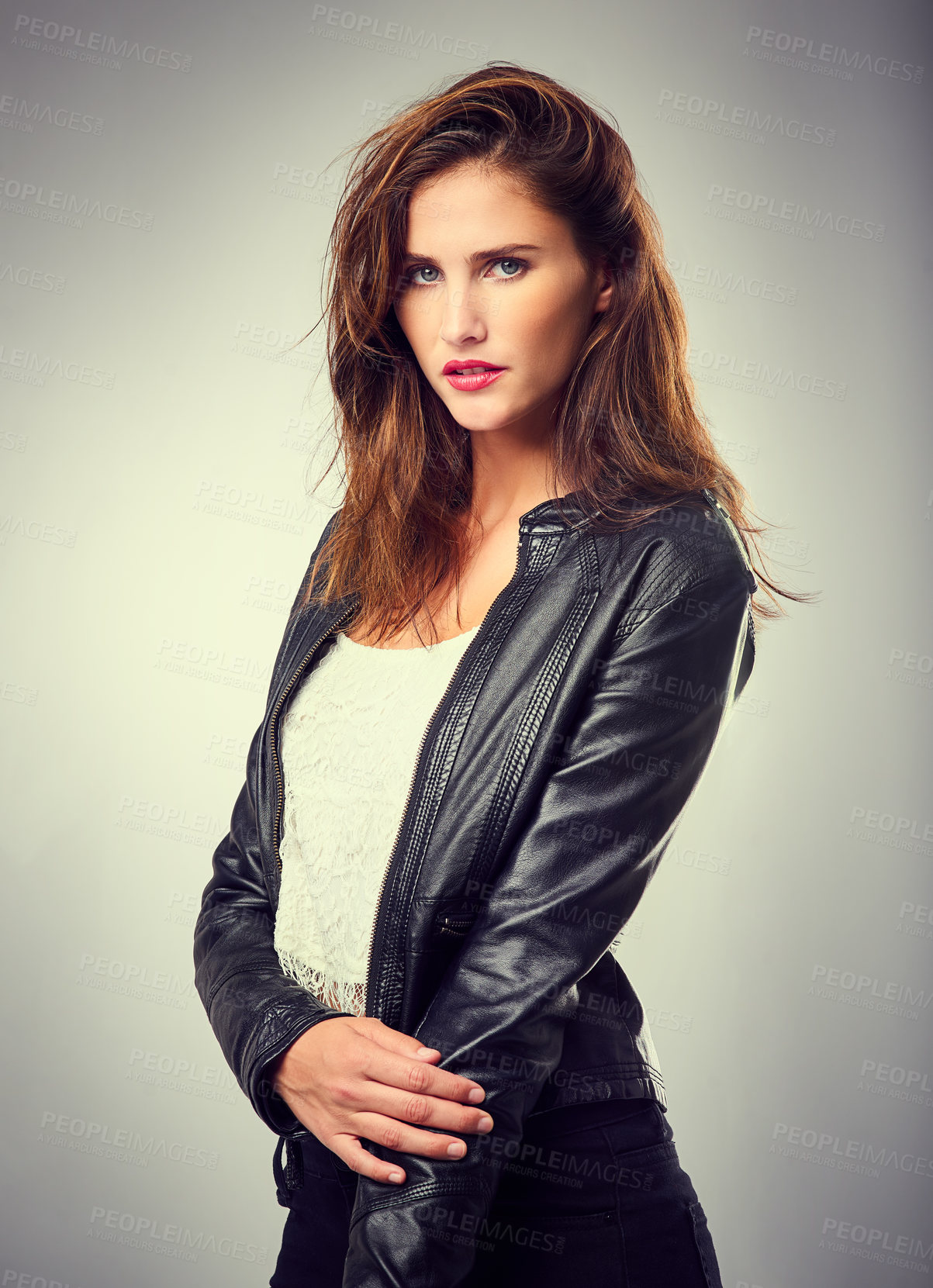 Buy stock photo Studio shot of a stylishly dressed young woman posing against a coloured background 