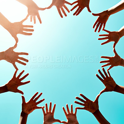 Buy stock photo Cropped shot of a group of unidentifiable businesspeople joining their hands in a gesture of unity