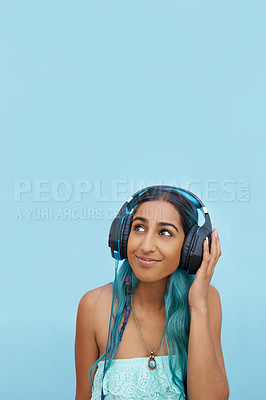 Buy stock photo Music, thinking and Indian woman with headphones in city for sound, track or listening to podcast on blue background. Streaming, earphones or gen z student outdoor with radio, playlist or audio ebook