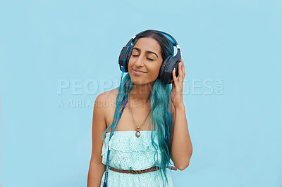 Buy stock photo Woman, headphones and music with listening, mockup space and blue wall background on campus. Student, relax and podcast audio or radio for education, college and confidence for university break