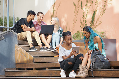 Buy stock photo Shot of a group of young students enjoying a break outdoors on campus