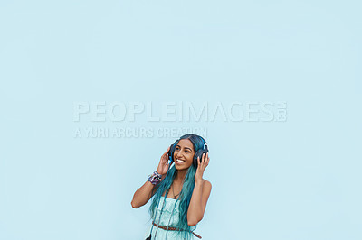 Buy stock photo Woman, headphones and smile with music, mockup space and blue wall background on campus. Student, listen and podcast audio or radio for education, college and confidence for university break