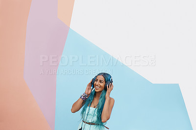 Buy stock photo Woman, headphones and color with music, mockup space and blue wall background on campus. Student, listen and podcast audio or radio for education, college and confidence for university break