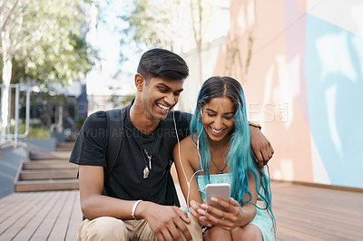 Buy stock photo Shot of a young student couple enjoying a break outdoors on campus