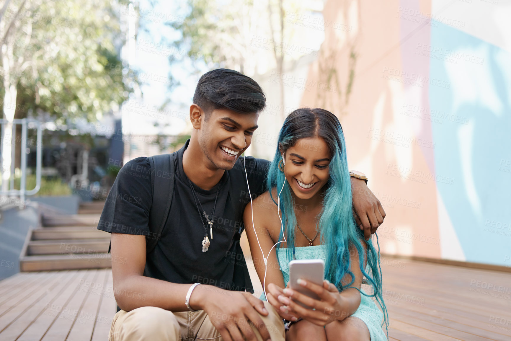 Buy stock photo Shot of a young student couple enjoying a break outdoors on campus