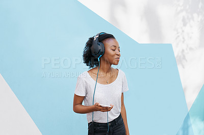 Buy stock photo Black girl, headphones and phone for music in studio, website and online for playlist on backdrop. Female person, mockup space and internet for social media, kpop and app for audio and streaming fun