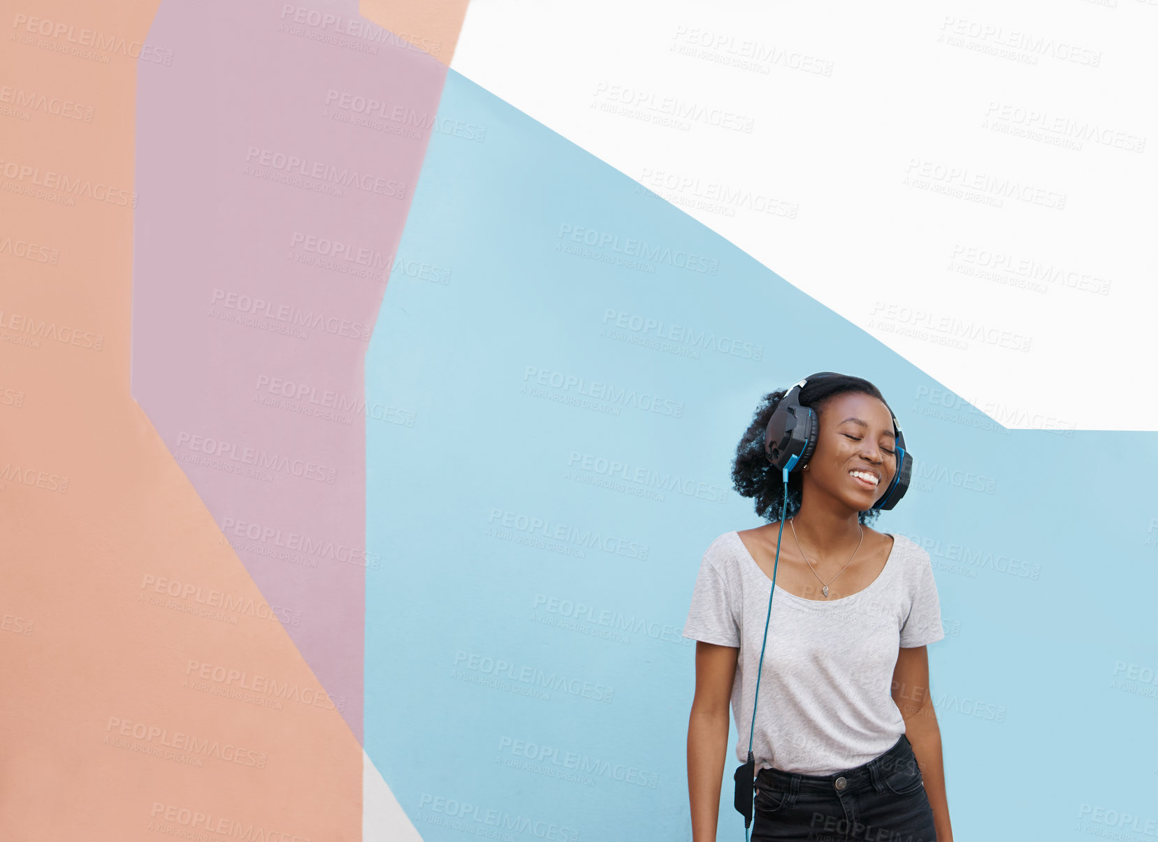 Buy stock photo Music, smile or black woman with headphones in city for sound, track or listening to podcast on wall background. Streaming, mockup or gen z African student outdoor with radio, playlist or audio ebook