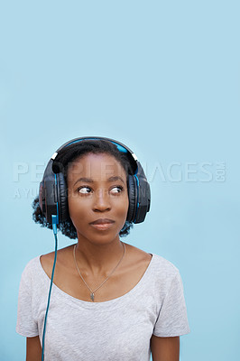 Buy stock photo Music, thinking and black woman with headphones in city for sound, track or listening to podcast on blue background. Streaming, earphones or gen z student outdoor with radio, playlist or audio ebook