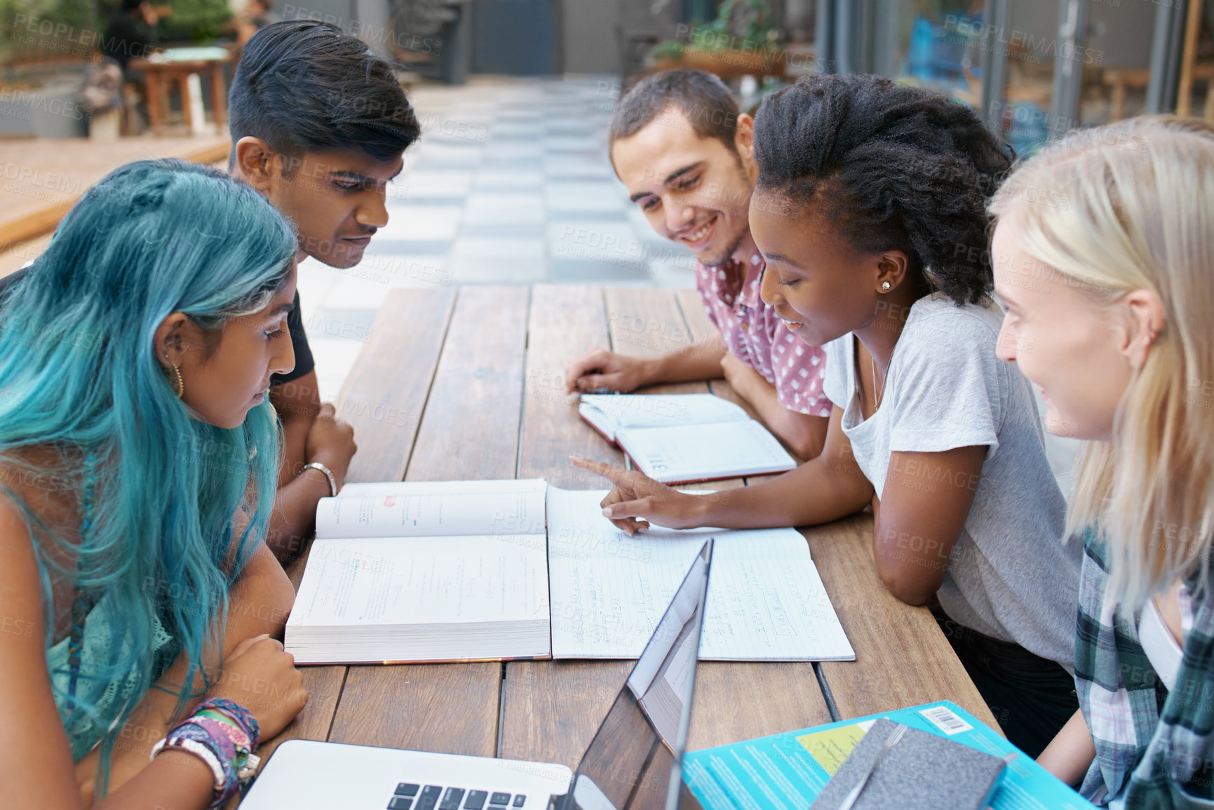 Buy stock photo Students, group and reading outdoor at university with books, listening and learning for education on campus. Friends, gen z people and team research with study, diversity and smile by college table