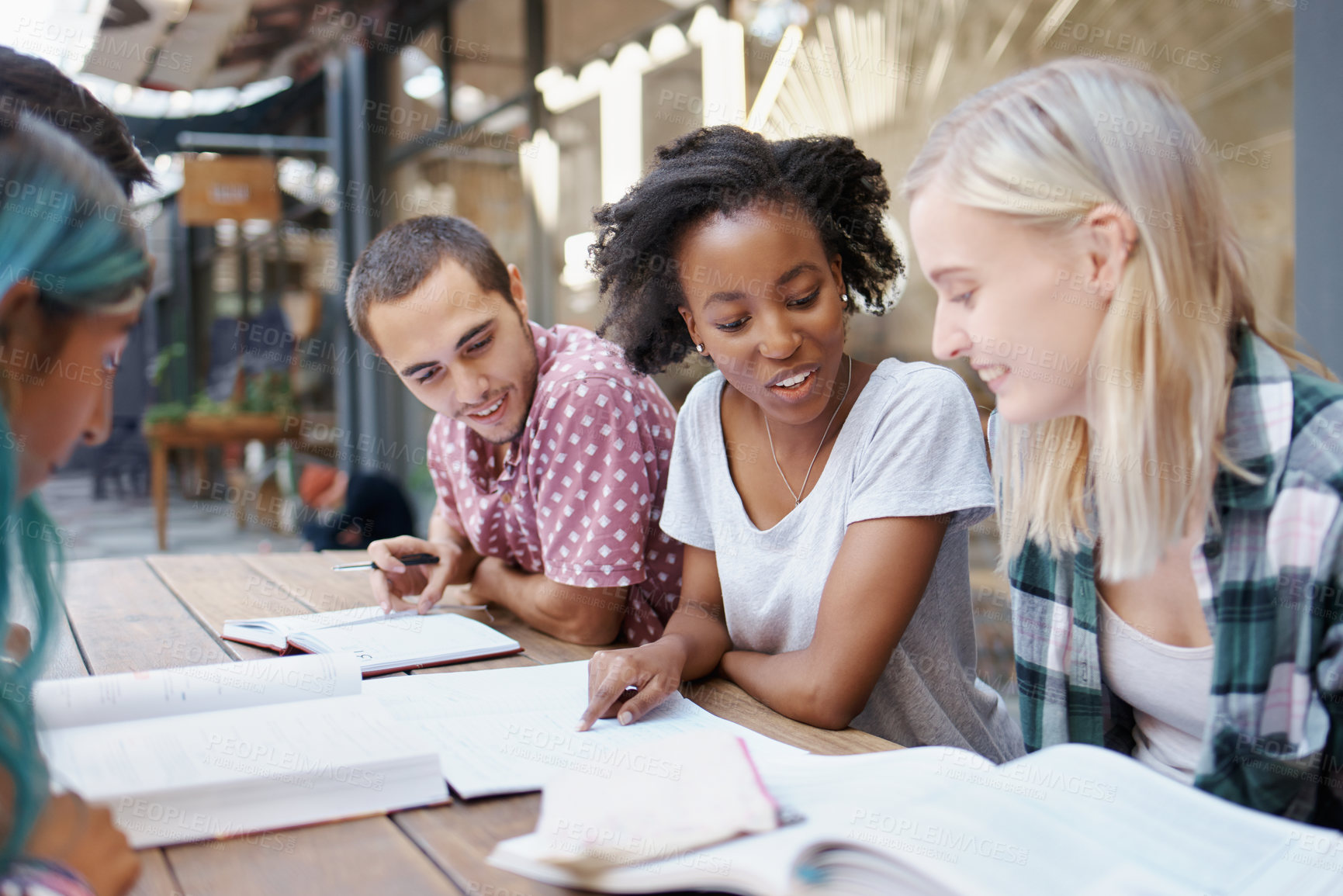 Buy stock photo Shot of a group of young students enjoying a break outdoors on campus