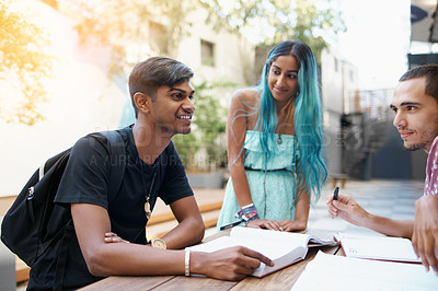 Buy stock photo Friends, group and study outdoor at university with books, listening or learning for education on campus. Students, gen z people and teamwork research with smile, diversity and college break by table