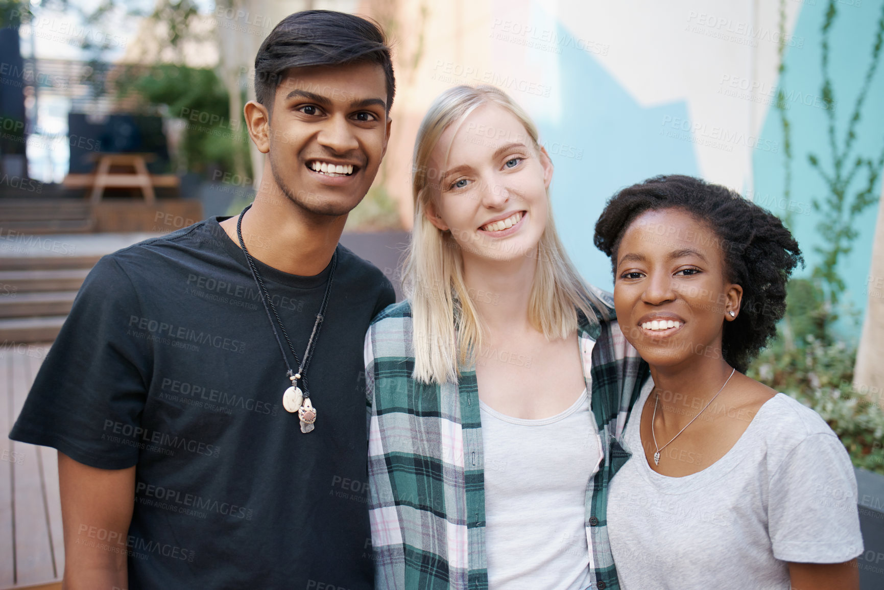 Buy stock photo Shot of a group of happy young friends spending time together outside