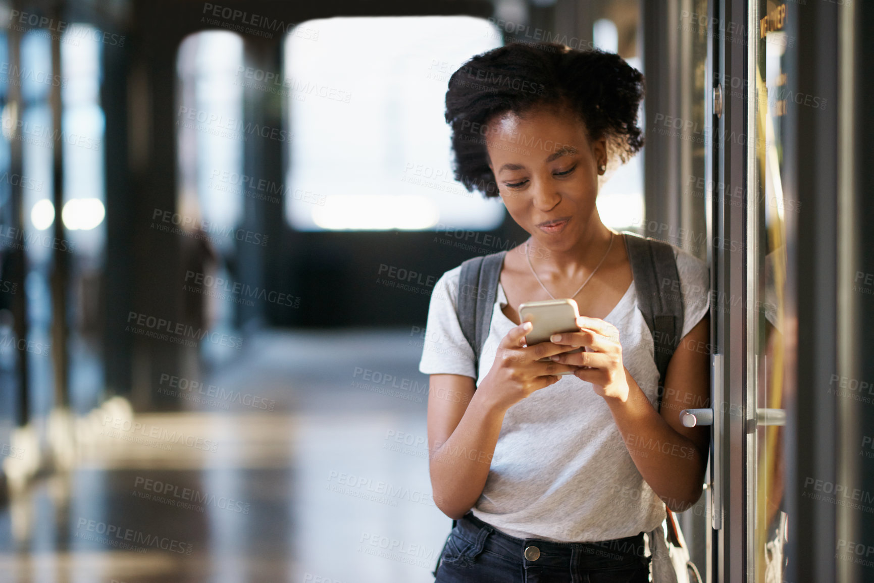 Buy stock photo Shot of a young woman using a mobile phone at university