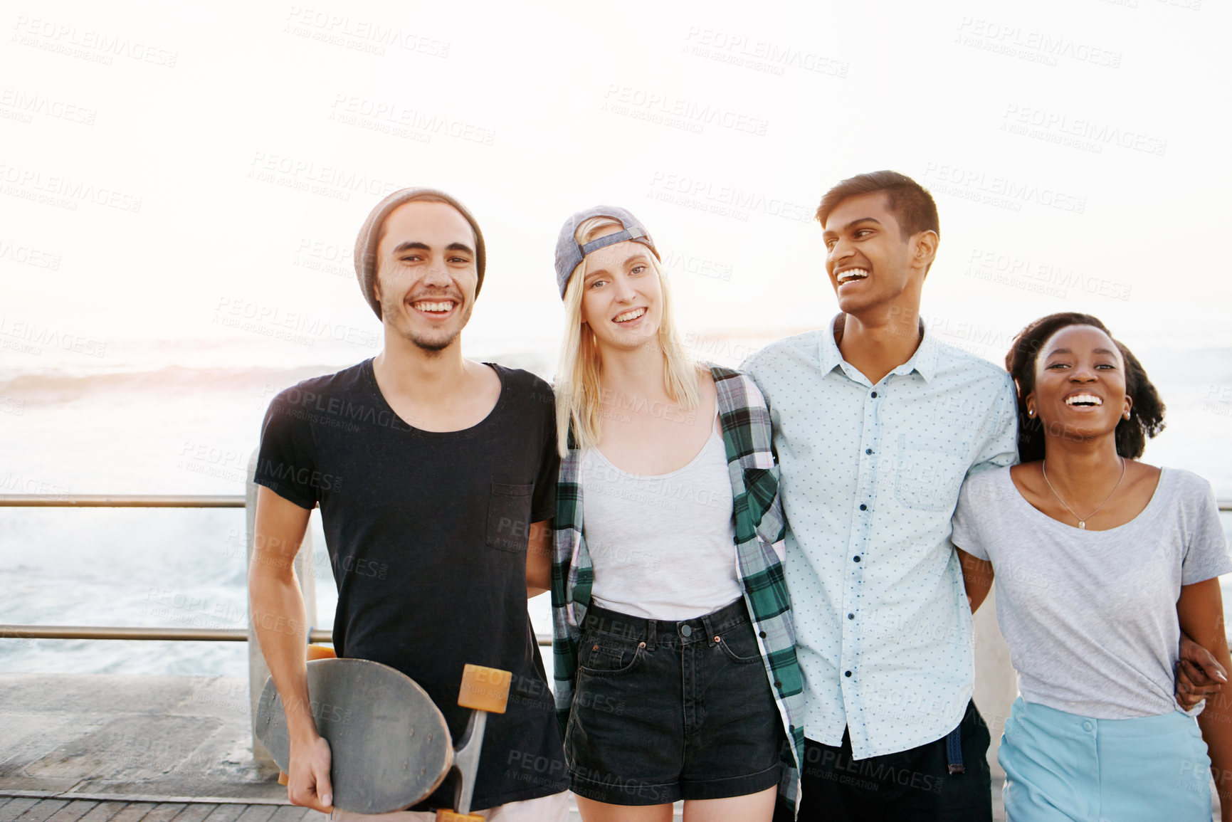 Buy stock photo Group, friends and portrait with hug on promenade by ocean for diversity, bonding or care at sunset. Men, women or gen z people with smile, embrace or relax on boardwalk with streetwear on vacation