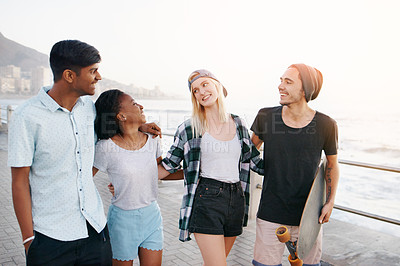 Buy stock photo Couple of friends, diversity and happy with skateboard at beach in summer or hot weather, together and support in London. People, laughing and bonding for holiday or vacation with smile in boardwalk