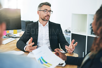 Buy stock photo Shot of corporate colleagues working together in their office