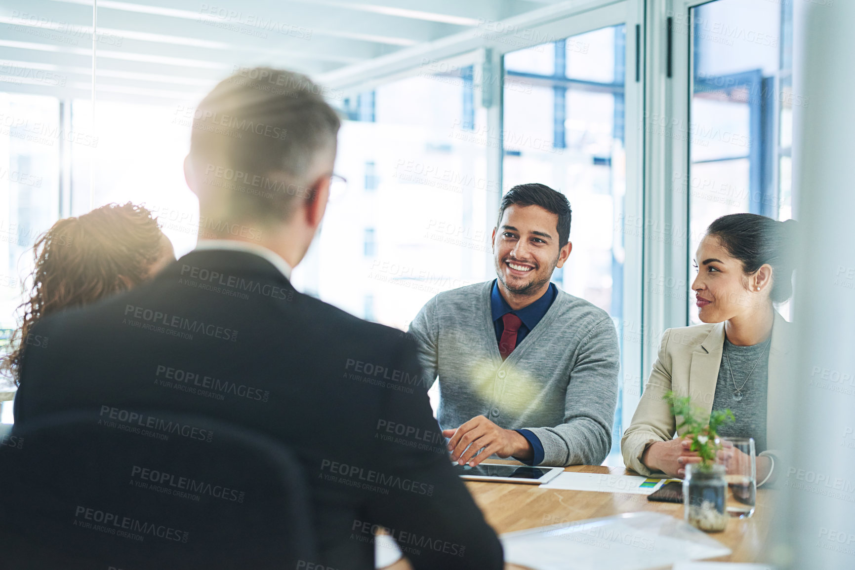 Buy stock photo Shot of corporate colleagues working together in their office