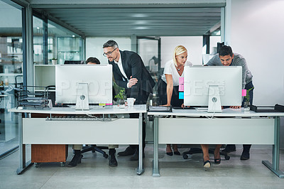 Buy stock photo Shot of corporate colleagues working together in their office