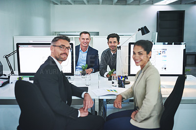 Buy stock photo Shot of corporate colleagues working together in their office