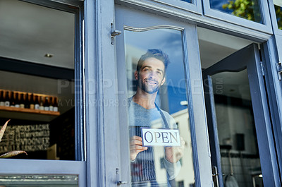 Buy stock photo Manager, window and open sign in cafe for small business with welcome, service industry and startup. Male entrepreneur, opening time and signage by door for advertising, barista job and coffee shop