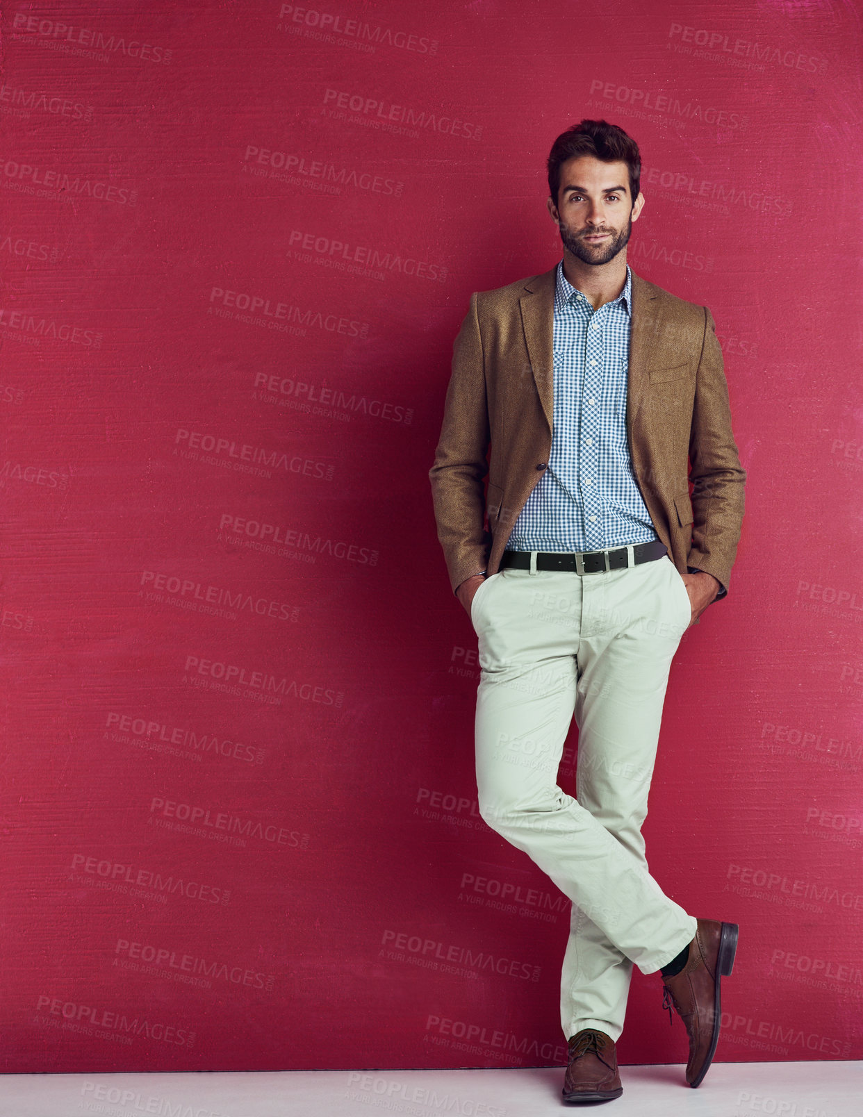 Buy stock photo Business, fashion and portrait of man with confidence, creative and professional in studio. Mockup, trendy style and businessman on red background space with pride, opportunity and designer clothes