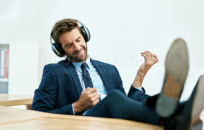 Buy stock photo Shot of a handsome young businessman in his office