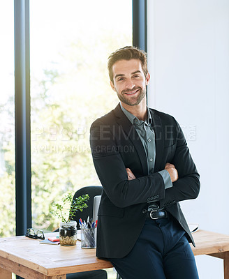 Buy stock photo Shot of a handsome young businessman in the office