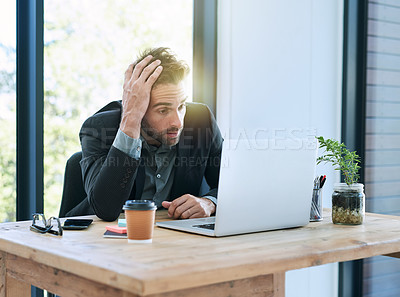 Buy stock photo Shot of a handsome young businessman in the office