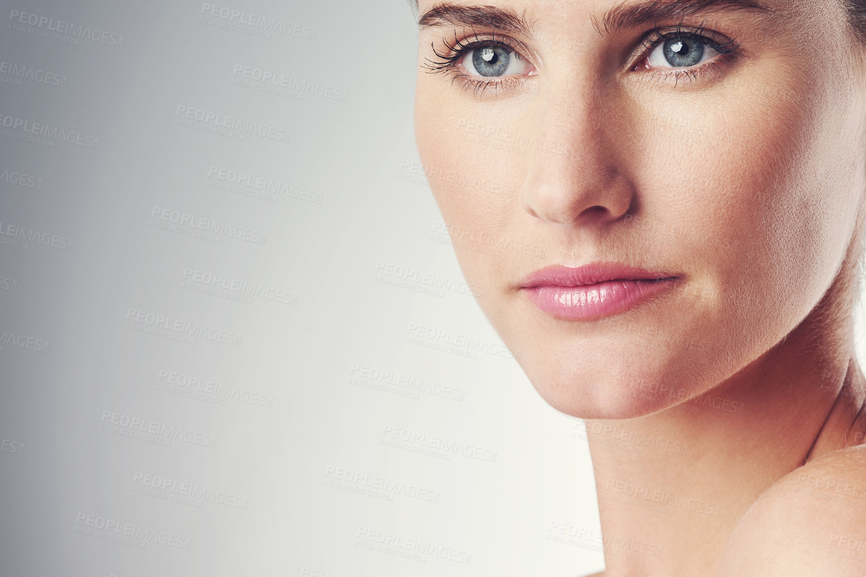 Buy stock photo Studio shot of a beautiful young woman posing against a gray background 