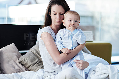 Buy stock photo Postpartum, child and mom is sad in the bedroom with mental health and anxiety to love children. Baby, mom and depression on bed with problem at family home is tired of insomnia due to worry.