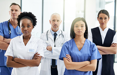 Buy stock photo Healthcare, crossed arms and portrait of team of doctors standing in the hallway with confidence. Serious, diversity and group of medical workers in the corridor of a medicare clinic or hospital.