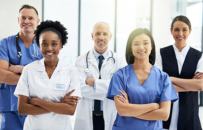 Buy stock photo Confidence, crossed arms and portrait of team of doctors standing in the hallway with collaboration. Happy, diversity and group of healthcare workers in the corridor of a medical clinic or hospital.