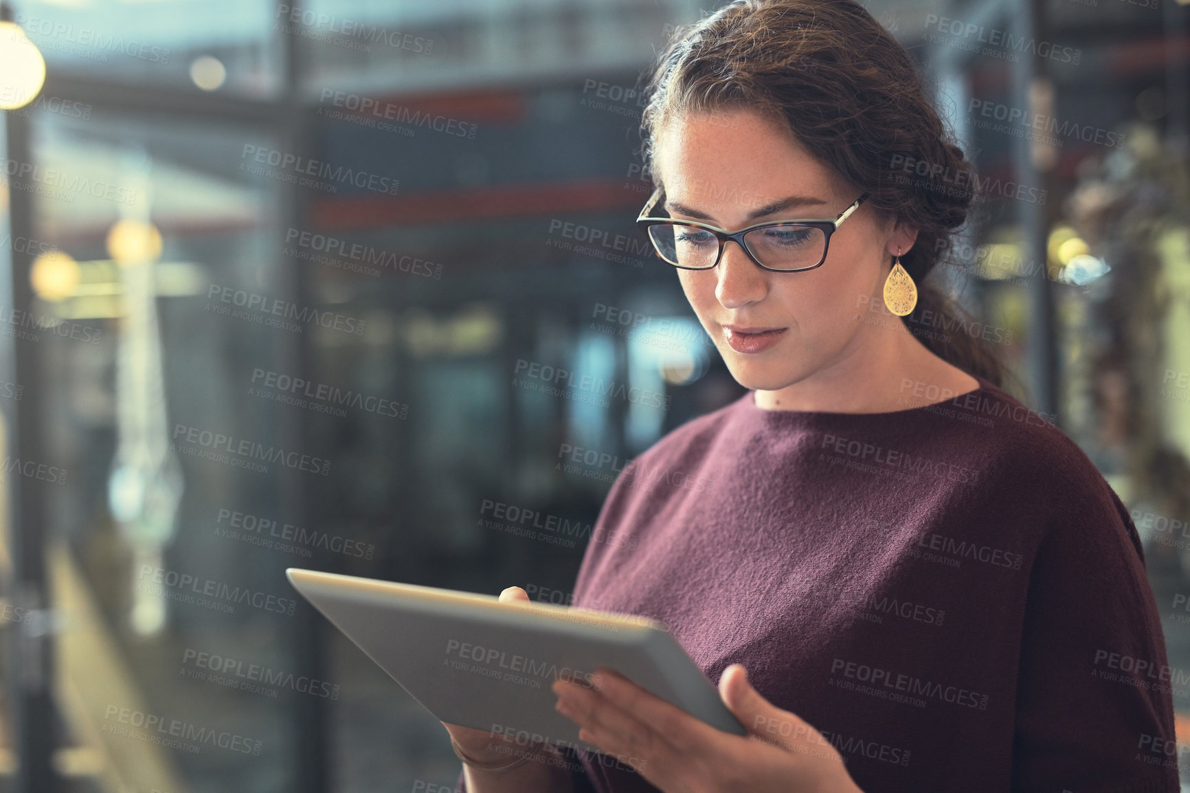 Buy stock photo Shot of a young woman using a tablet indoors 