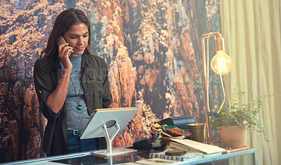 Buy stock photo Shot of a young woman working on a tablet in a store 