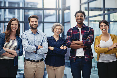 Buy stock photo Portrait of a group of creatives standing with their arms folded in the office