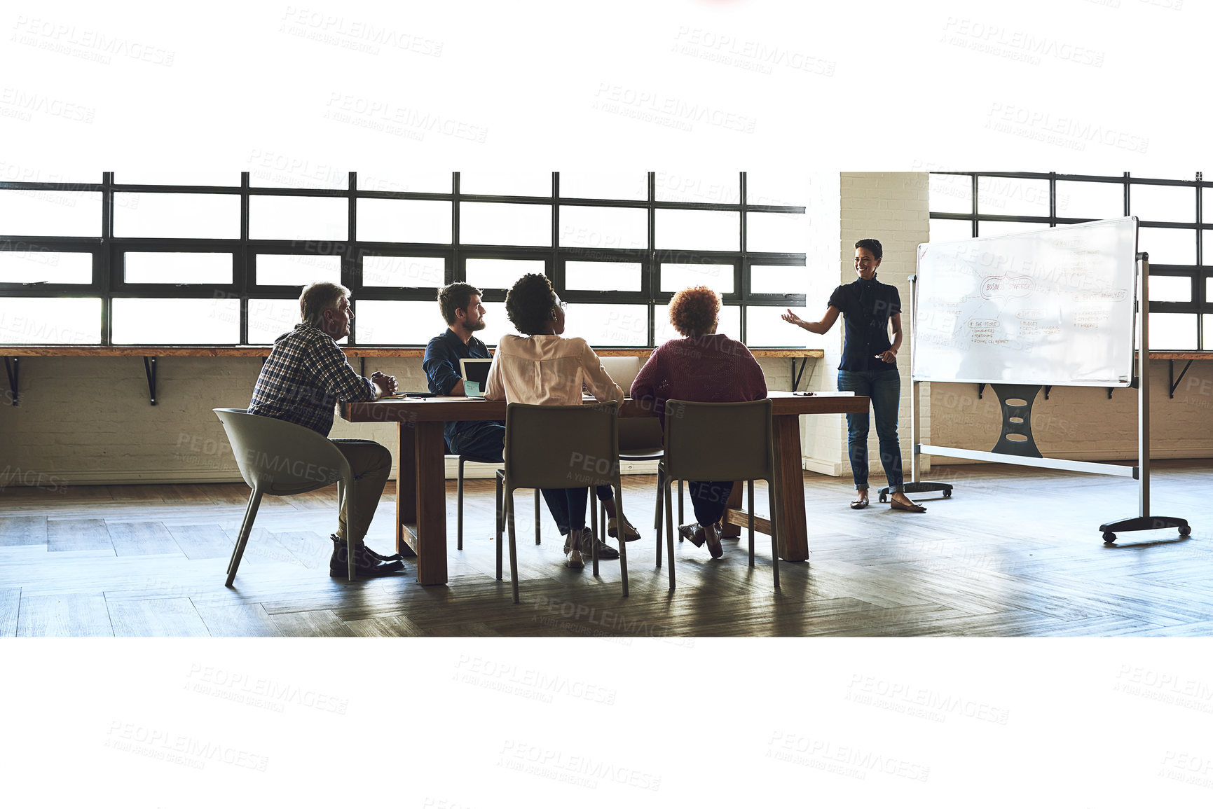 Buy stock photo Shot of a group of colleagues having an office meeting inside