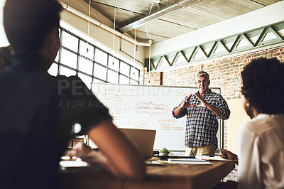 Buy stock photo Shot of a group of colleagues having an office meeting inside