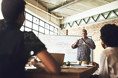 Buy stock photo Man, whiteboard and presentation for strategy at meeting for team, feedback or mindmap with training at job. People, group and mature speaker with review, question and business plan in modern office