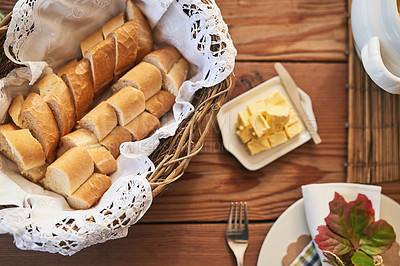 Buy stock photo Buffet table, flatlay of bakery bread with butter in buffet and kitchen counter with wood texture background. Restaurant with brunch food, healthy meal for dinner and plate of lunch with cutlery