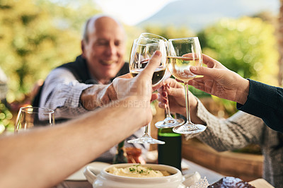 Buy stock photo Friends, wine and toast on a patio with happy, cheerful and people celebrating and sharing a meal outdoors. Family, hands and cheers in celebration of holiday, traditional and happy family gathering 