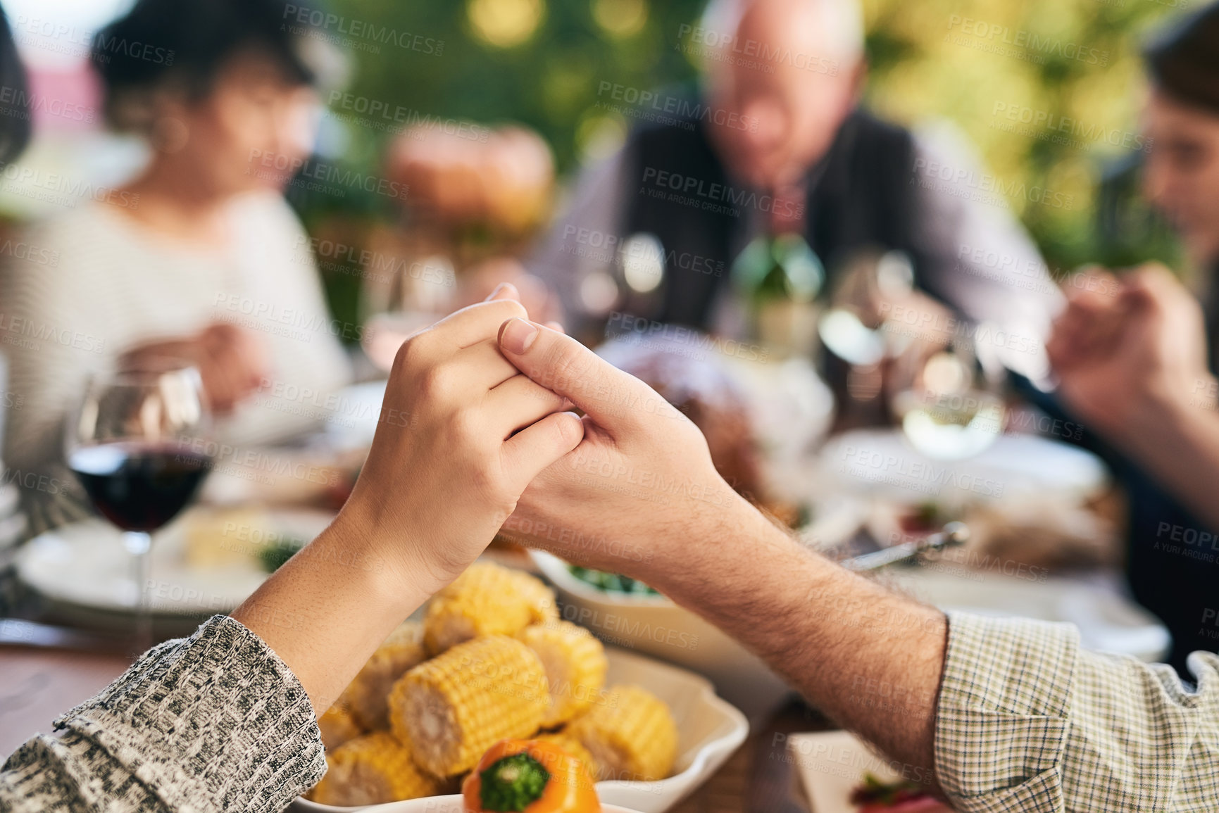 Buy stock photo Party, food and family holding hands for prayer before eating chicken, barbecue or turkey at a social event. Corn, Christmas and Christian friends praying before enjoying meat and vegetables meal